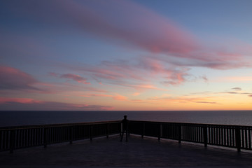 Fototapeta na wymiar By Myself at Pink and Blue Horizon Sea Sunset Overlook