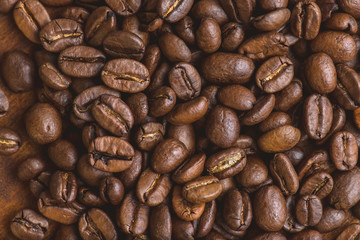 Brown roasted coffee beans, closeup macro for background and texture