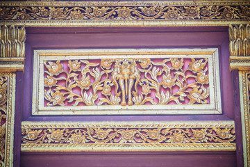 Beautiful craved Buddha with animals in forest patterns on the gables of the Thai's northern style church at Wat Chedi Liam, one of the ancient temple in Wiang Kum Kam archaeological area, Chiang Mai.