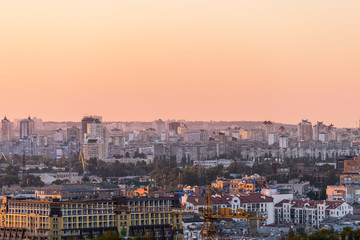 Kyiv, Ukraine cityscape skyline of Kiev downtown area during colorful orange sunset and old apartment buildings in evening
