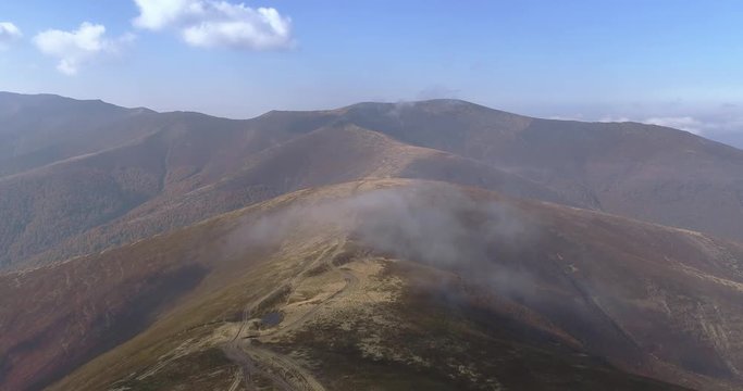 Aerial view: Flying over an amazing mountain near the peak of Gemba. 4k
