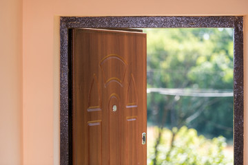 Rustic house home farm cottage dacha in Europe with wooden open door entrance and green garden in summer