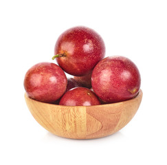 Passion fruit in wooden bowl isolated on white background