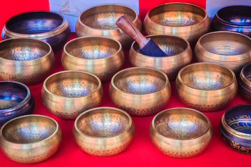 Tibetan singing bowls for sale at the antique market. Singing bowls also known as rin gongs, Himalayan bowls or suzu gongs are used worldwide for meditation, music, relaxation, and personal well-being