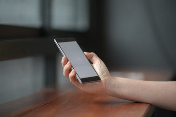 Closeup female hand holding mobile smart phone