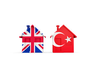Two houses with flags of United Kingdom and turkey