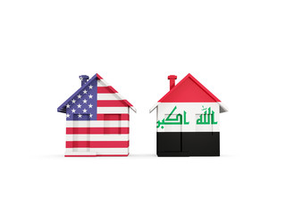 Two houses with flags of United States and iraq
