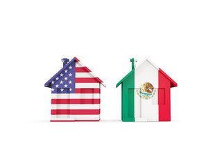Two houses with flags of United States and mexico