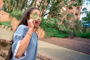 Miss holds a sheet with which one eye is covered while sticking out her tongue