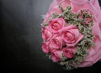 Pink rose bouquet on black cement background