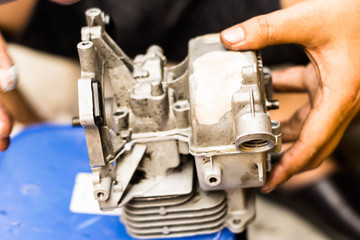 The mechanic is repairing the engine and cleaning the spare 