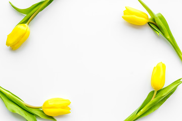 Spring composition. Bouquet yellow tulips on white background top view copy space frame