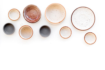 Ceramic tableware pattern. Empty plates and mugs on white background top view space for text