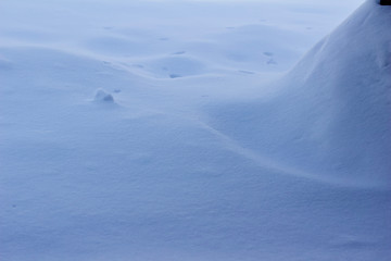 Fototapeta na wymiar Smooth drifting snow textured landscape closeup