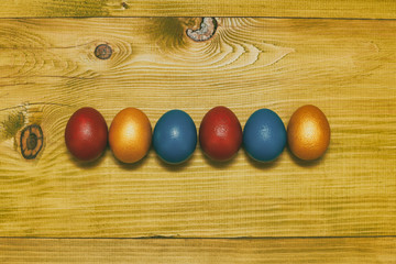 Painted Easter eggs on wooden table.Toned photo