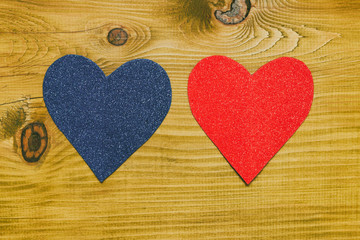 Image of blue and pink heart shape on wooden table.Toned photo.	