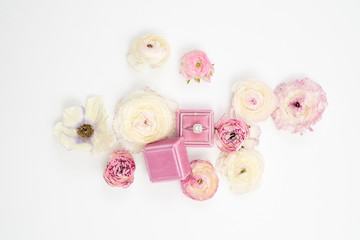 Fototapeta na wymiar Ranunculus and Anemone Flower Background with Wedding Ring in Velvet box