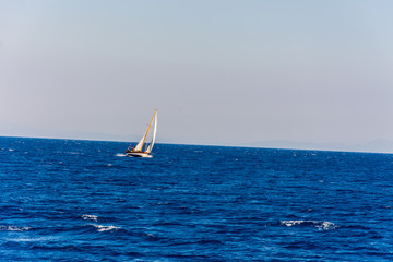 The small boat sailing in the Aegean sea