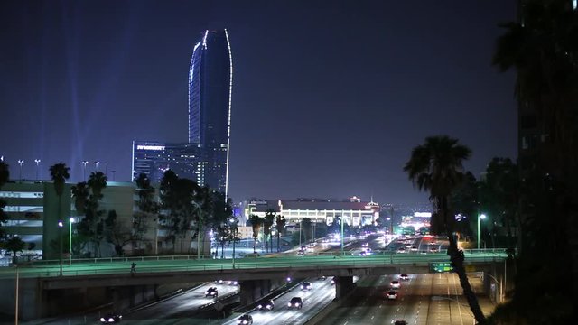 WS Traffic on highway and skyscraper illuminated ay night / Los Angeles, California, USA