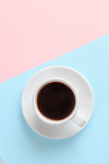 Obraz na płótnie Canvas cup of coffee on blue and orange background