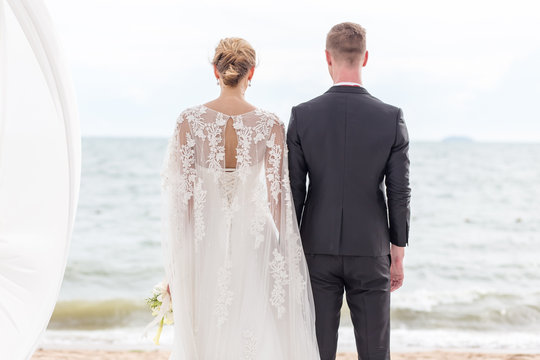 Bride and groom on the beach with a romantic moment