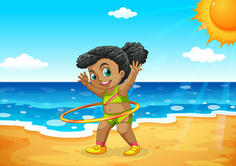 Young girl hoola hooping on beach