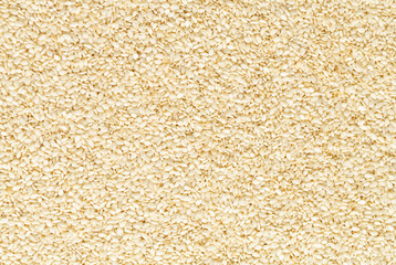 Closeup of lots of toasted sesame seeds. Sesame seeds background