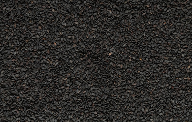 A lot of healthy black sesame seeds. Top view. Textured background of dark sesame.