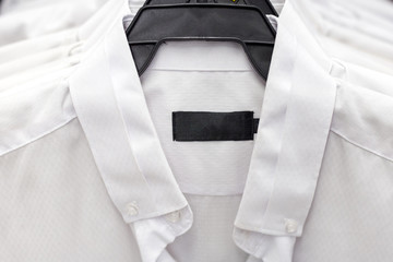 white formal shirts hanging on a hanger