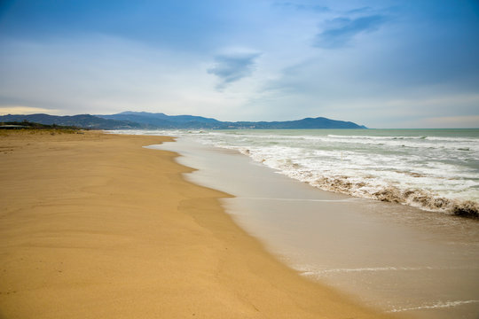 Empty sand beach in Paestum in cloudy day in winter, Cilento, Italy