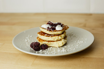 Tasty curd cheesecakes with coconut chips and blueberries. The most beautiful breakfasts for lovers