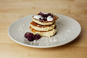 Tasty curd cheesecakes with coconut chips and blueberries. The most beautiful breakfasts for lovers