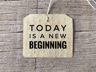 Motivational and inspirational wording - Today Is A new Beginning written on a paper tag.