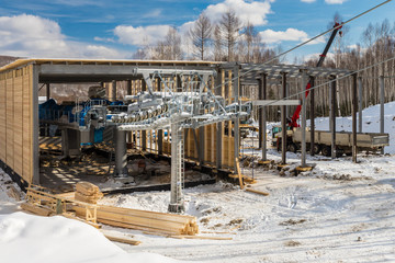 Сonstruction of ski lift mechanism and landing pavilion in winter.
