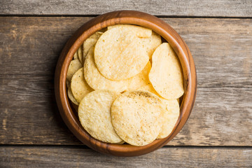 Salty chips on the rustic background. Selective focus. Shallow depth of field.