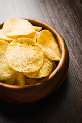 Salty chips on the rustic background. Selective focus. Shallow depth of field.