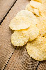 Salty chips on the rustic background. Selective focus. Shallow depth of field.