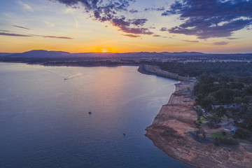 Aerial view of small boats sailing across Lake Hume at dusk. New South Wales, Australia
