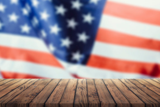 Us flag on a wooden old table. Concept of the 4th of July celebration,