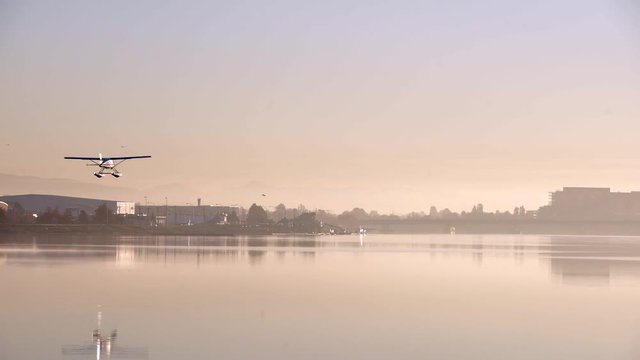 Float Plane Landing, Sunrise Mist 4K UHD. A float plane landing on the Fraser River at YVR. 4K. UHD.