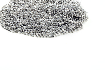 Yards of coiled metal linked jewelry chain