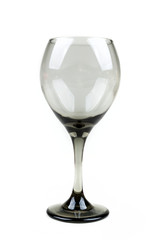 Empty smoked grey wine glass over a white background