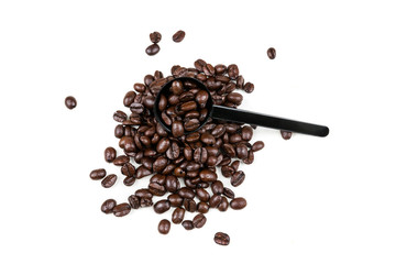 Small black plastic coffee scoop on a pile of roasted beans