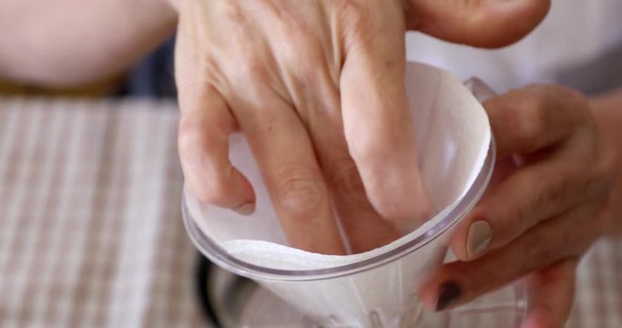 Placing paper filter in dripper to make hand drip coffee