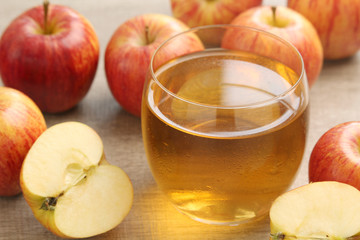 A glass with juice and apples