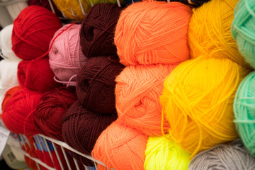 Coloured wool yarn into skeins and tangles. Bright yarn for knitting.