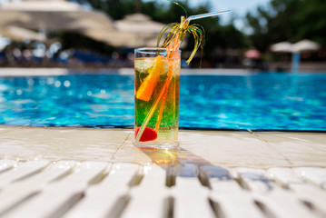 Fruit cocktail glass at pool - vintage filter effect