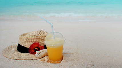 Relax on a tropical island, concept. Protection from sun and heat. Straw hat and pineapple juice