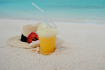 Relax on a tropical island, concept. Protection from sun and heat. Straw hat and pineapple juice