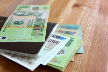 dong Vietnam money.Vietnamese banknotes many worth.Ho Chi Minh image on  banknote  on wood table
